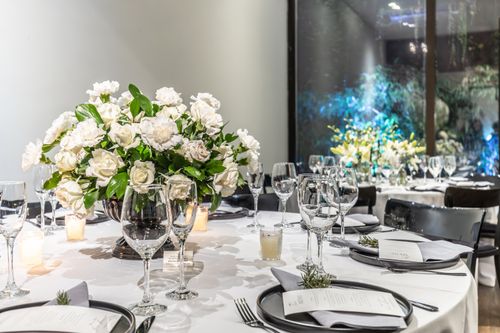 Free Beautifully arranged wedding table with white floral centerpiece, glassware, and candles. Stock Photo