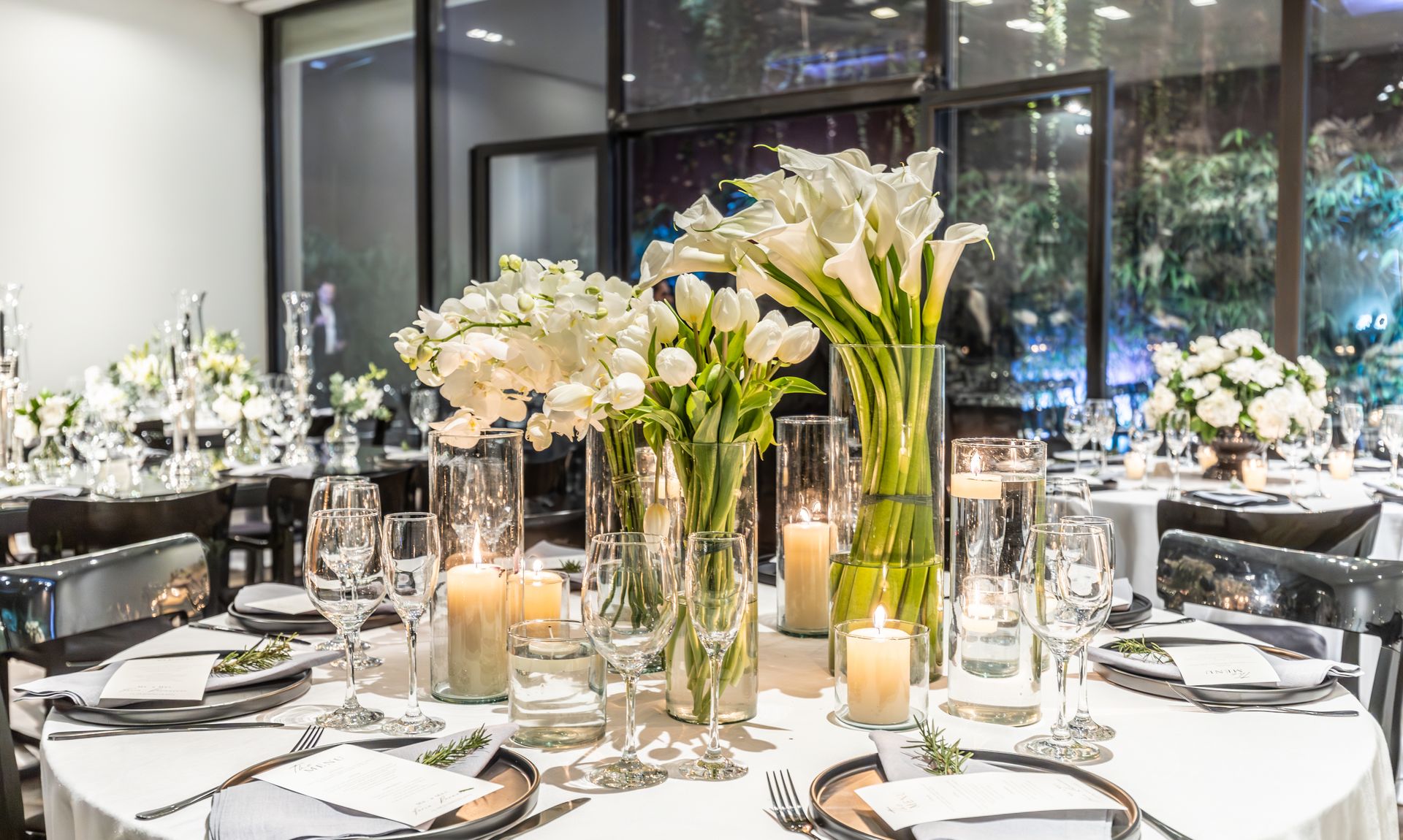 White-and-gold rectangular table with floating candles and blush chairs