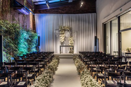 Free Beautifully decorated indoor wedding venue with elegant floral arrangements and seating. Stock Photo