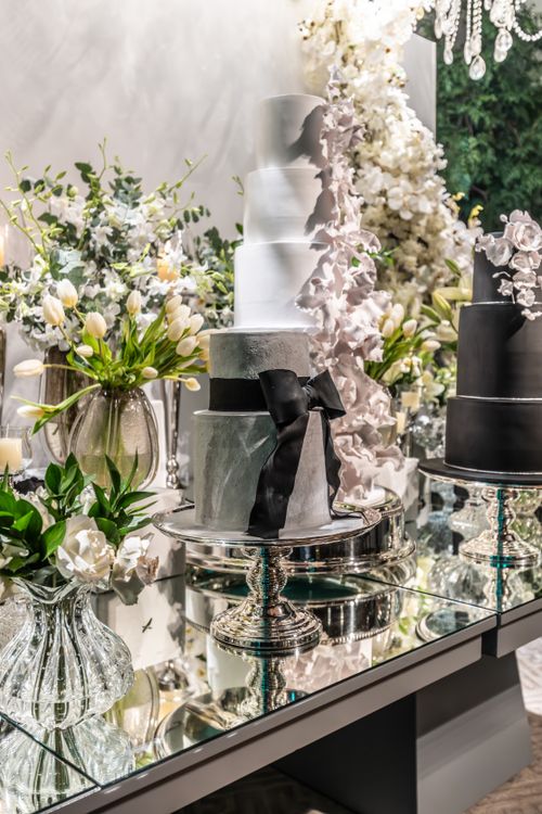Free Beautiful wedding cake setup with elegant decor and floral arrangement. Stock Photo