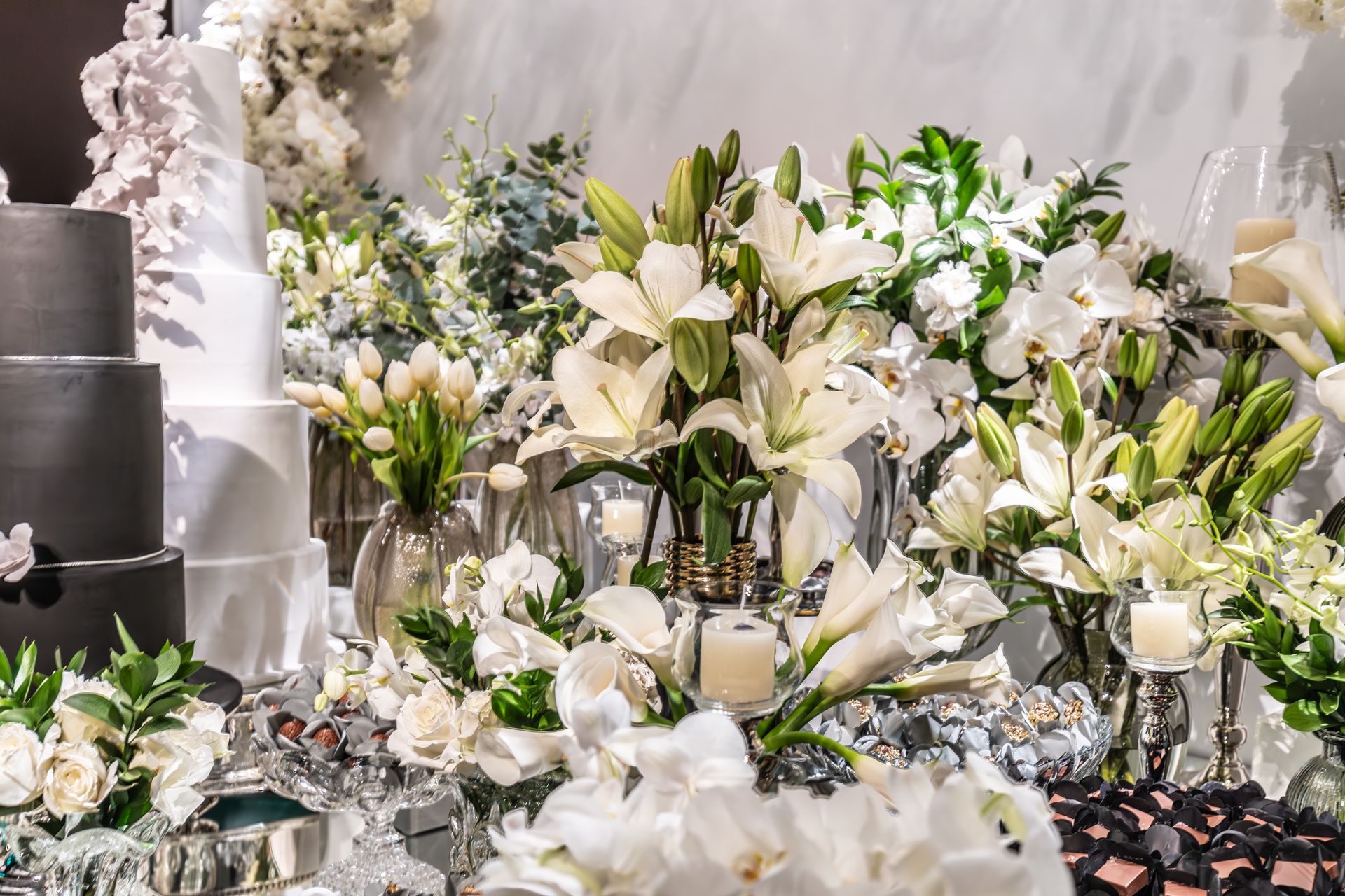 Luxurious flower arrangements and tiered cakes create a stunning wedding display.