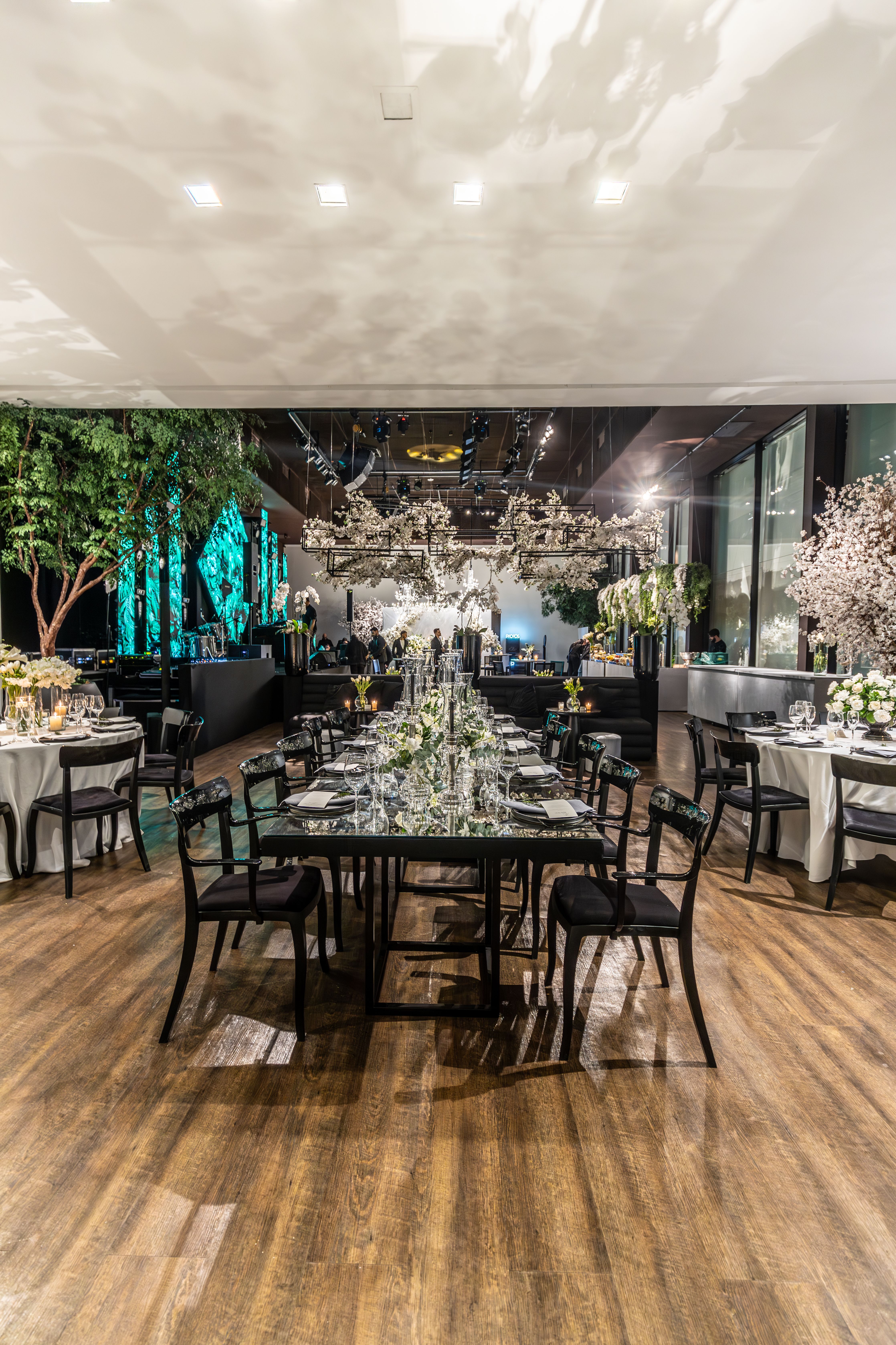 Luxurious wedding venue with floral arrangements and elegant table settings.