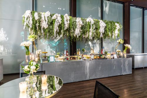 Free Bright and elegant banquet hall setup with hanging floral decorations for a wedding reception. Stock Photo