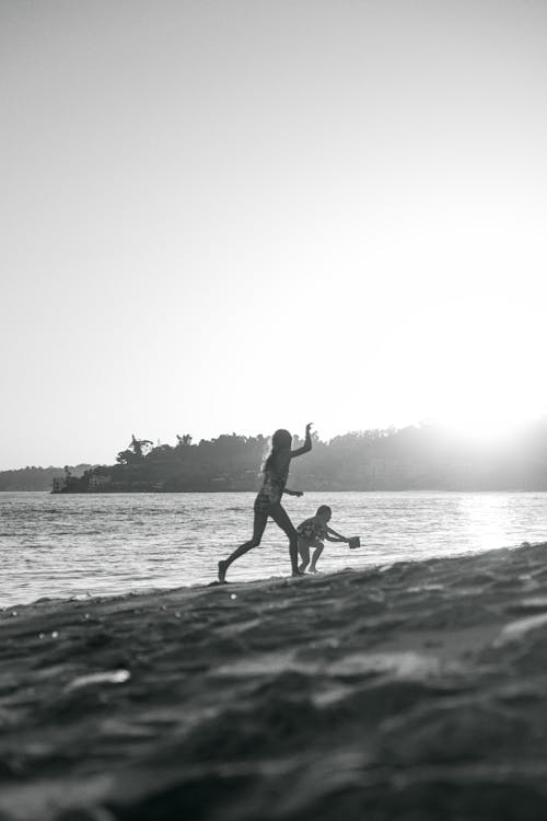 Children Playing on Beach at Sunset