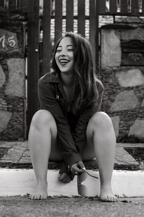 Smiling Woman Sitting in Black and White