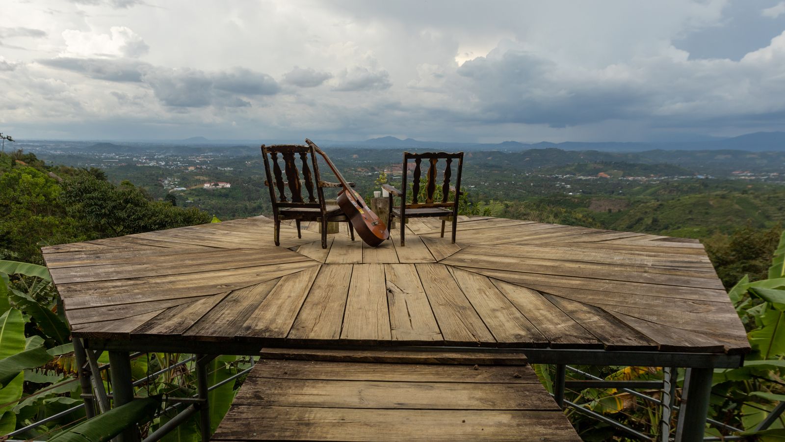 Double bass and chairs on terrace over plains, Ghana