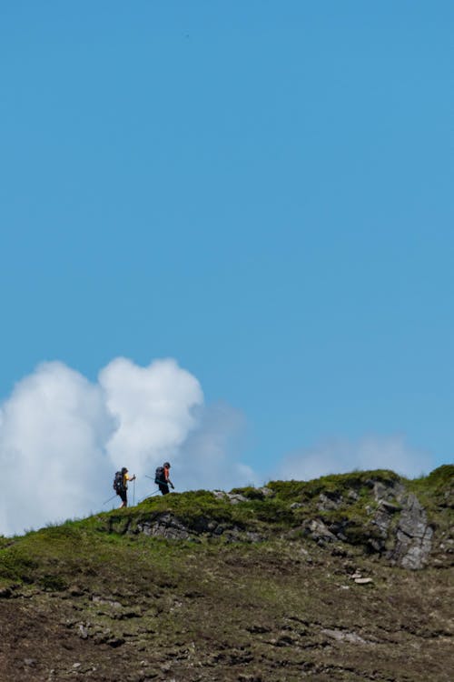 People on a Hill in a Mountain Valley 