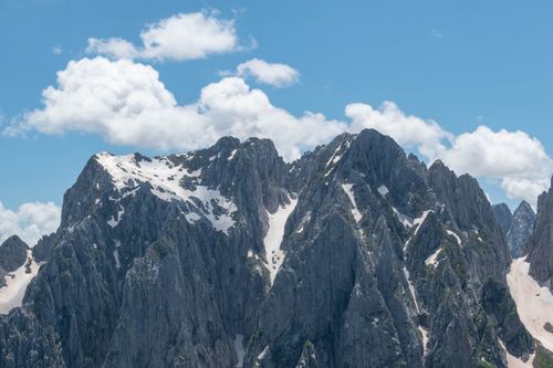 Free Rugged, snow-covered mountains under a bright blue sky in Montenegro's wilderness. Stock Photo