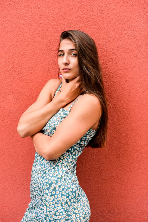 Woman Posing against Red Wall