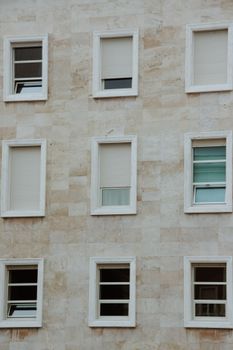 Close-up of a minimalist building facade featuring geometric windows.