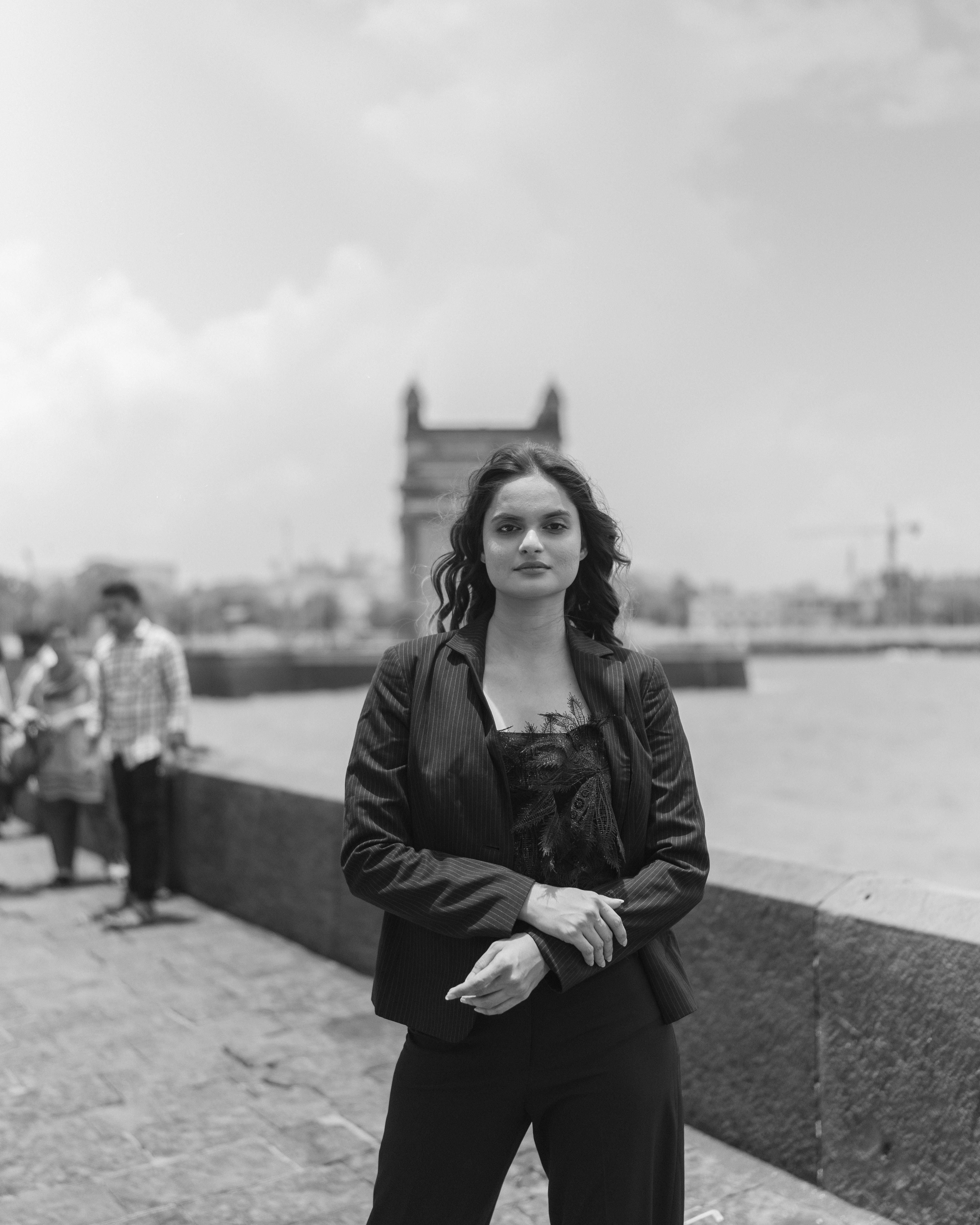 Woman Posing by Water in Town in Black and White · Free Stock Photo