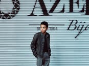 Man Standing Behind Gray Roller Shutter