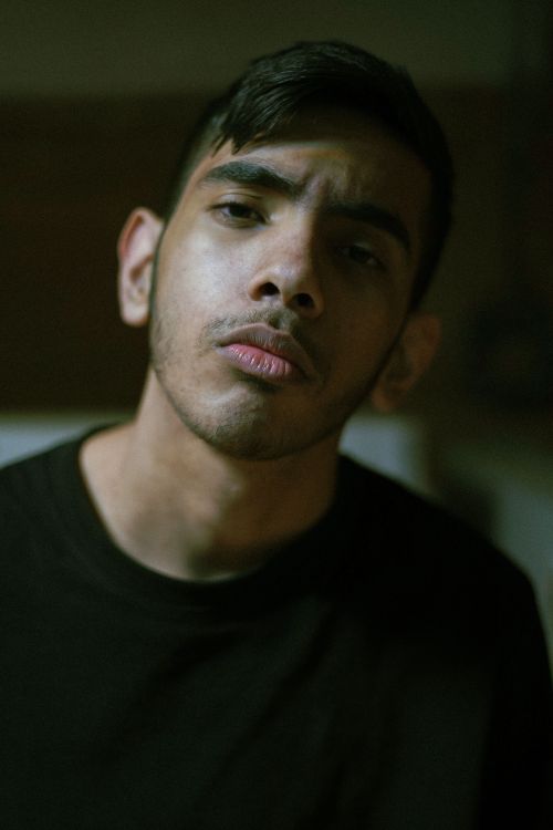 Free Close-up moody portrait of a young man with short hair in Tehran, Iran. Stock Photo