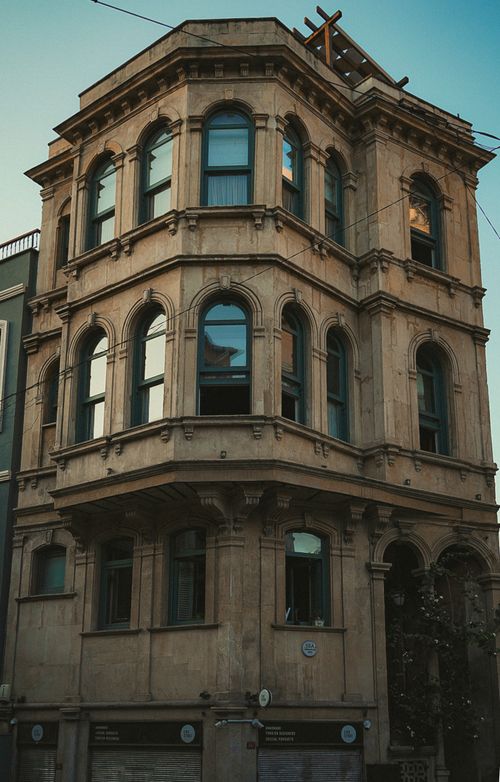 Free Elegant neoclassical style building facade with arcade windows in an urban district. Stock Photo