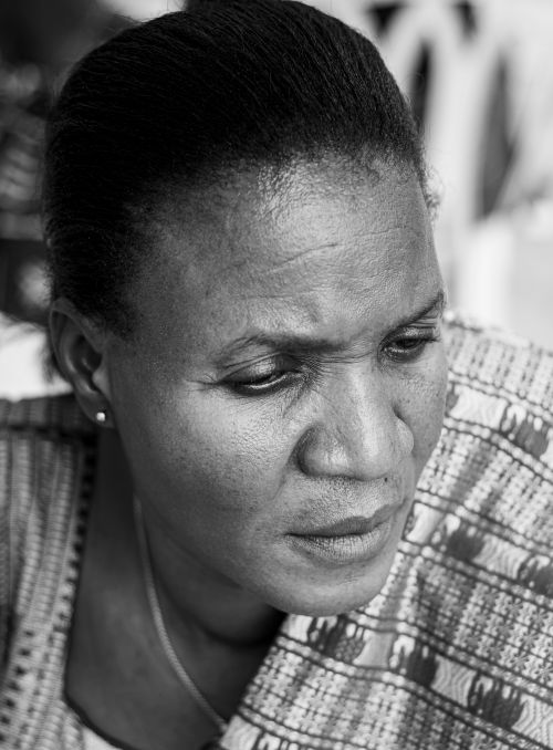 Free Black and white close-up portrait of a woman looking downward, conveying deep thought. Stock Photo