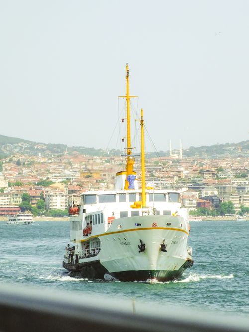 Free A ferry sailing in Istanbul against the cityscape and coast, showcasing Turkish urban life. Stock Photo