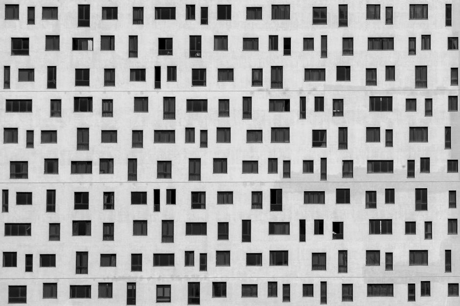 Geometric pattern of windows on a modern residential building facade.