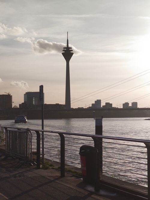Free A scenic view of Düsseldorf's skyline featuring the Rhine Tower during sunset. Stock Photo