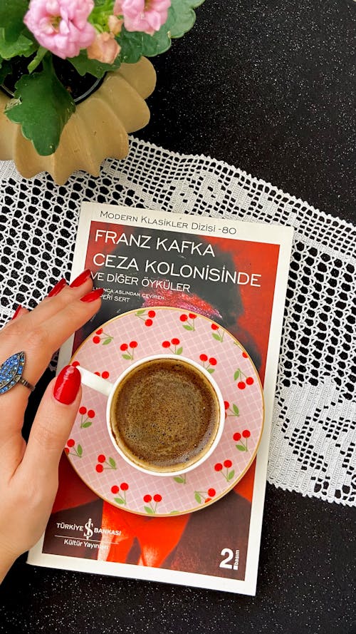 Woman Hand and Coffee over Franz Kafka Book in Turkish