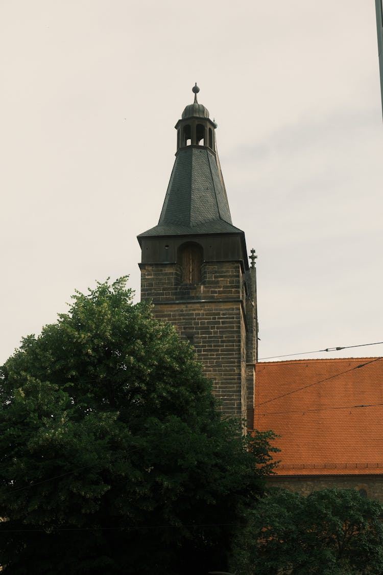 Medieval Church Tower Behind Tree