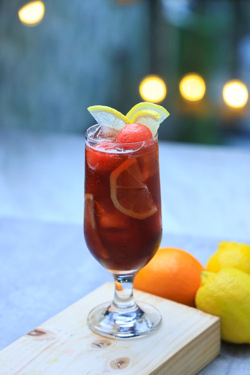 Free Chilled cocktail with citrus fruits and watermelon garnish, perfect for summer. Stock Photo