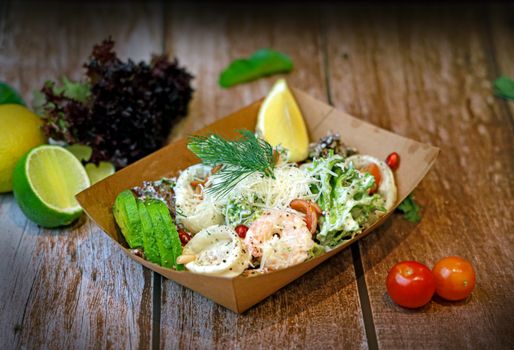 Vibrant seafood salad with avocado and lemon, served on a rustic table for a fresh and healthy meal.
