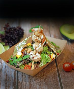Delicious shrimp salad with fresh greens, cherry tomatoes, and avocado, perfect for a healthy meal.