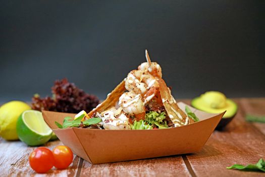 Delicious shrimp taco garnished with fresh vegetables, perfect for food lovers.