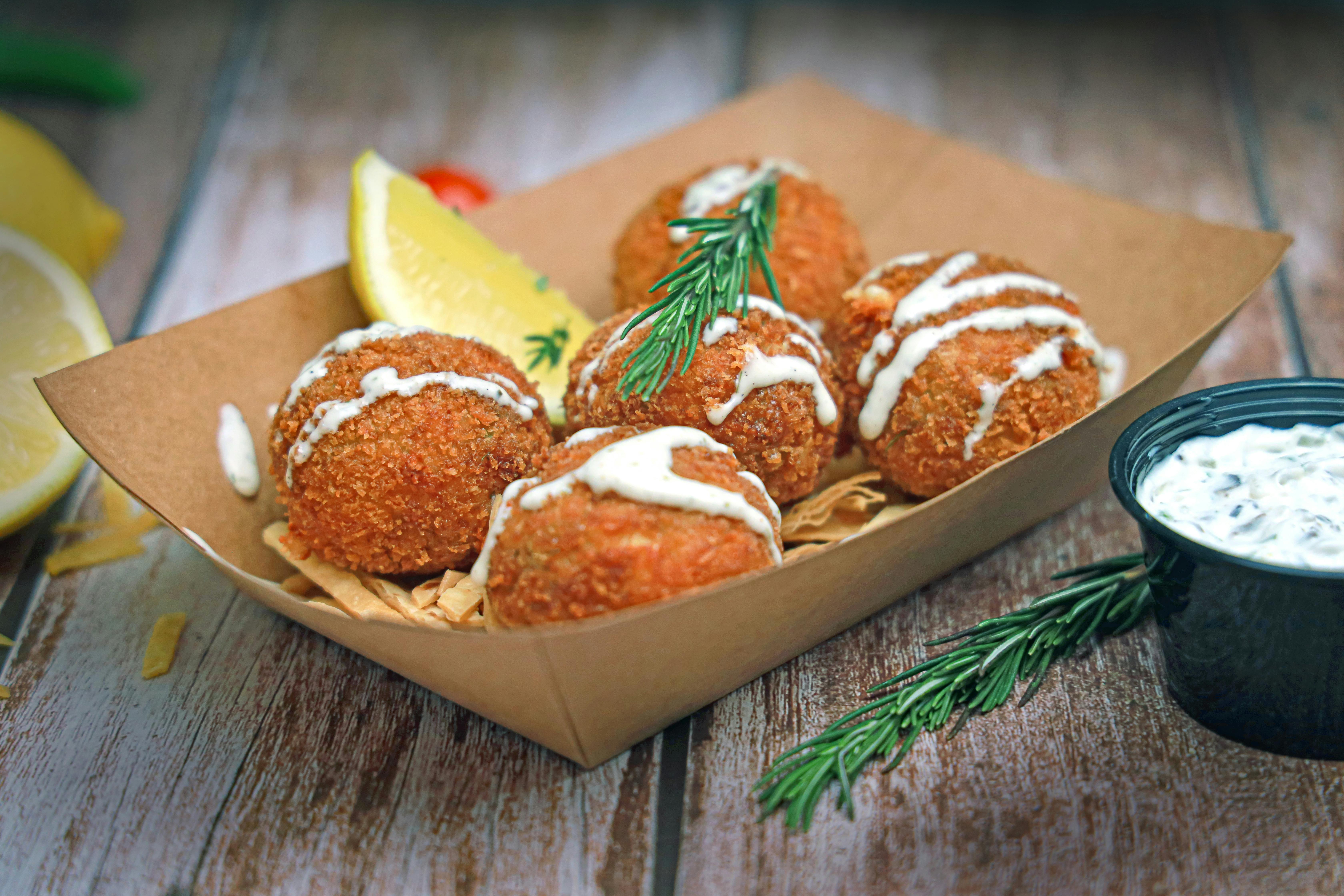 Delicious crab cakes served with tangy tartar sauce and fresh lemon wedges.