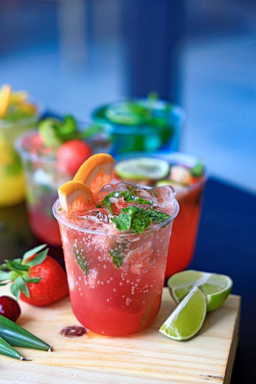 A variety of drinks are on a cutting board