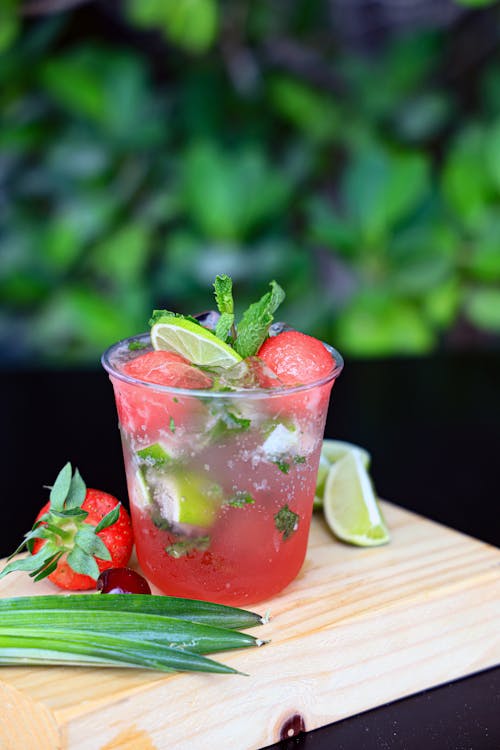 A glass of watermelon and lime juice with mint leaves