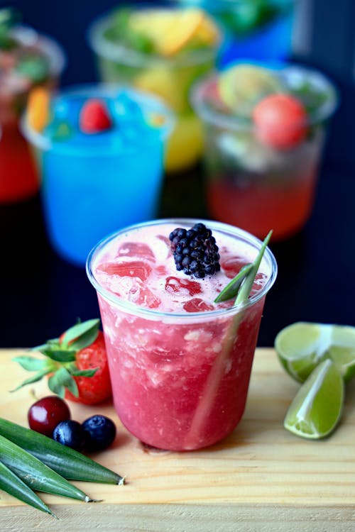 A drink with berries, lime and other ingredients