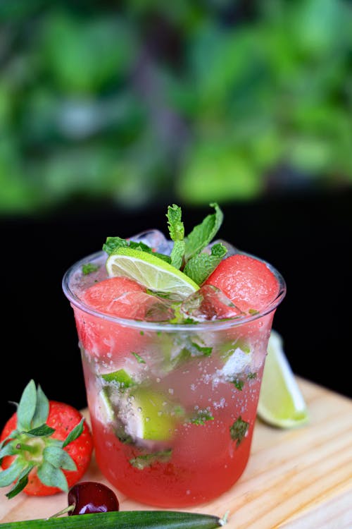 A drink with watermelon, lime and mint leaves