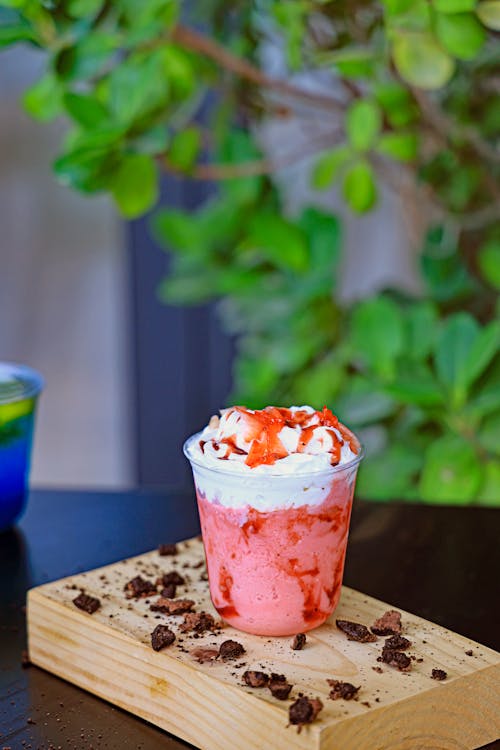 A strawberry drink on a wooden cutting board