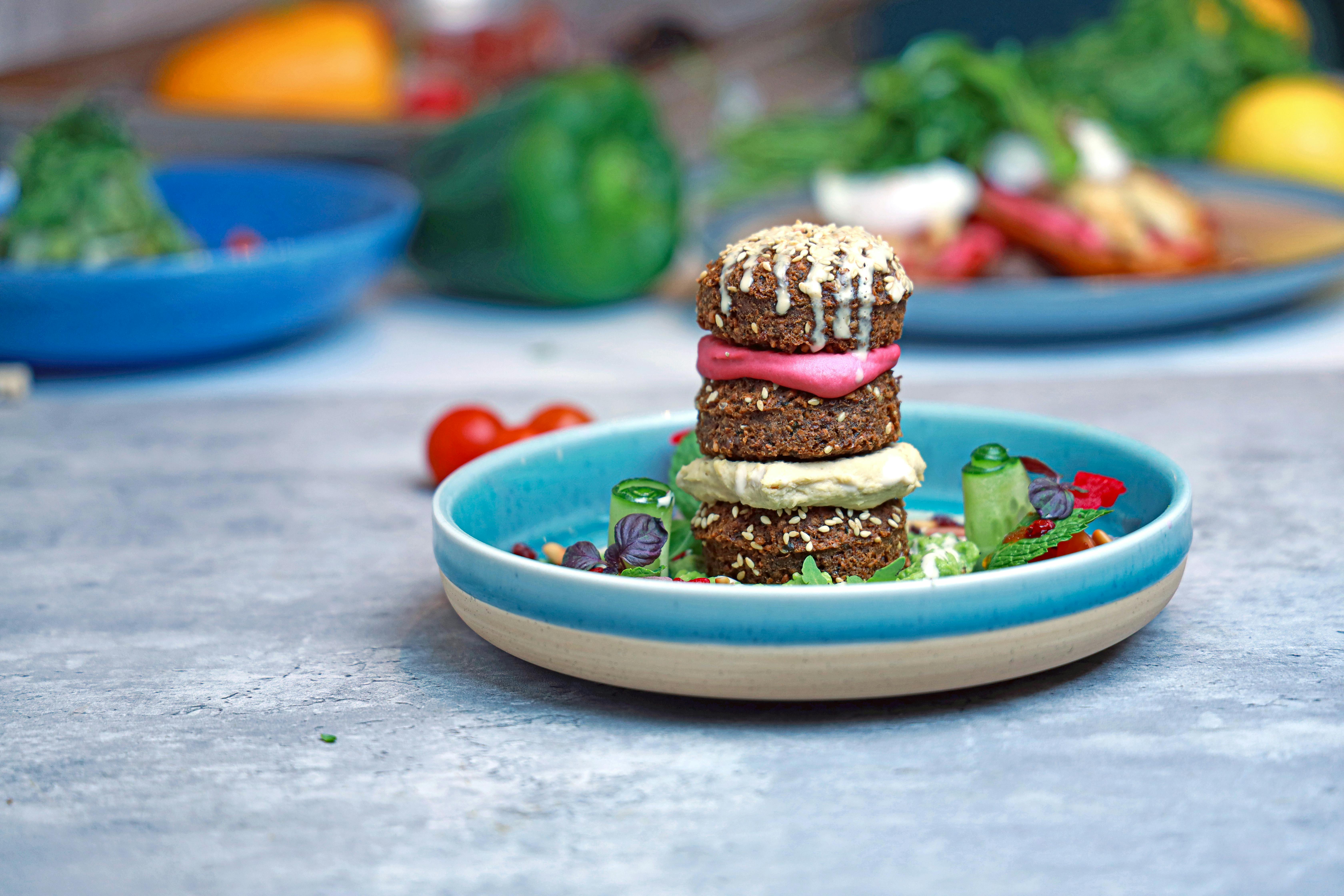 An artistic presentation of a vegetarian dish stacked elegantly on a ceramic plate, perfect for gourmet food lovers.