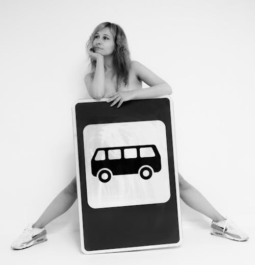 Naked Woman Posing with Bus Sign