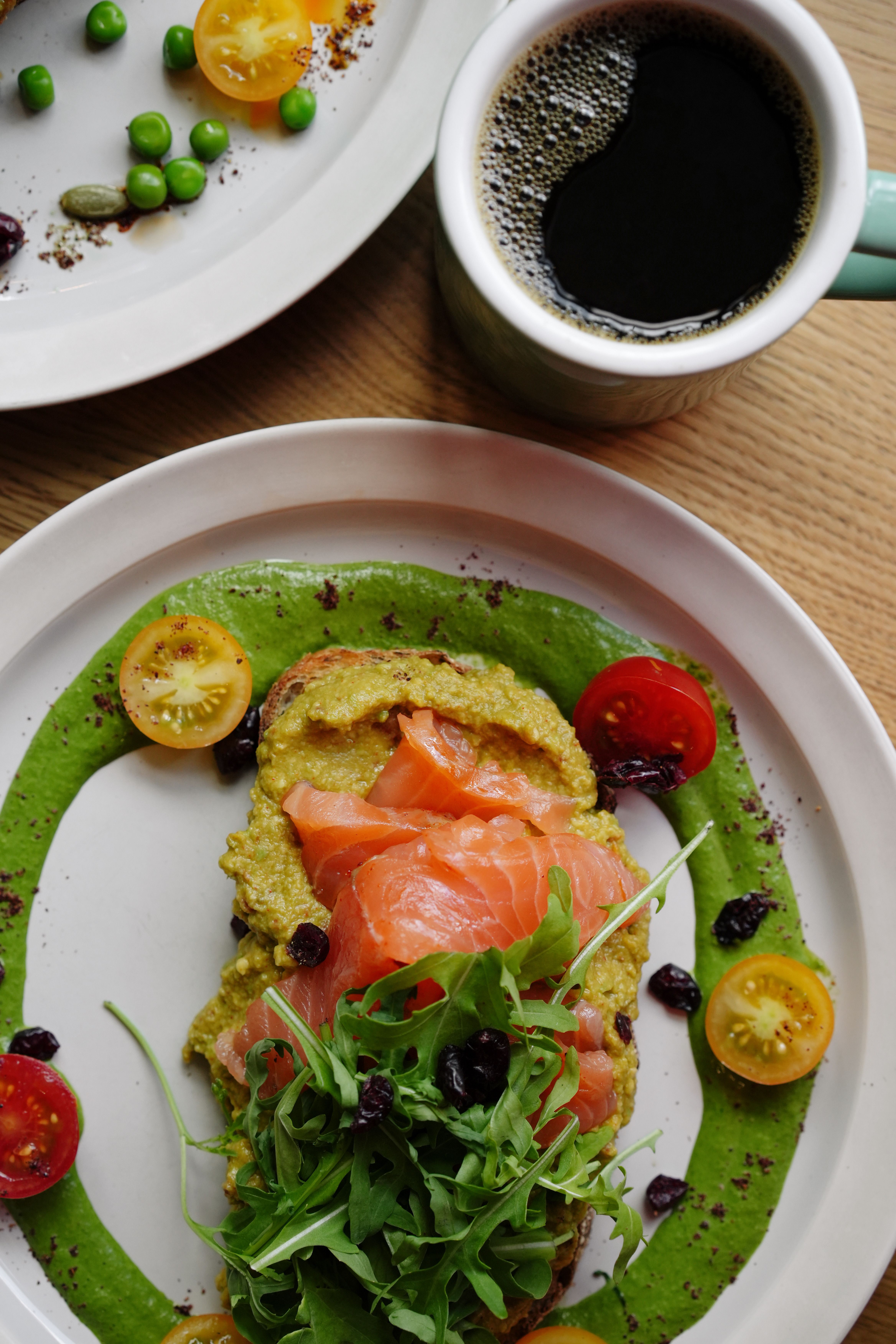 Vibrant breakfast plate of smoked salmon, arugula, and coffee. Perfect for a healthy start.