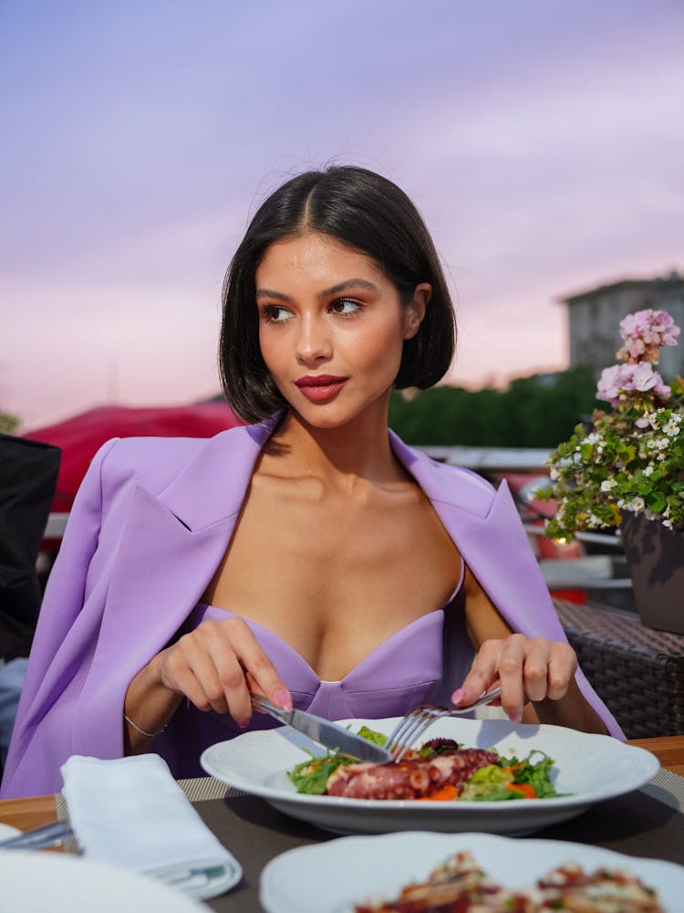 Young Woman Sitting At The Table In A Restaurant 