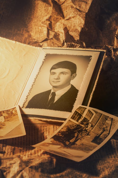 Sepia vintage portrait of nostalgic young man in formal suit with contemplative gaze symbolizing family history 