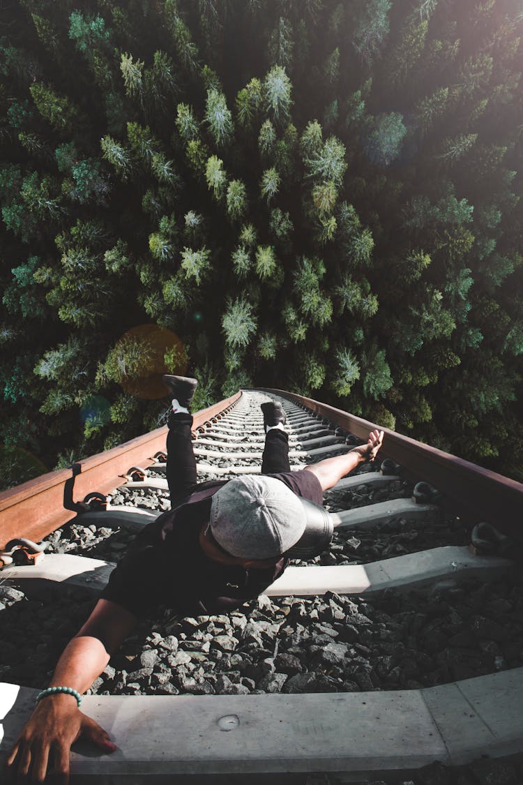 Man Holding On Gray Railing