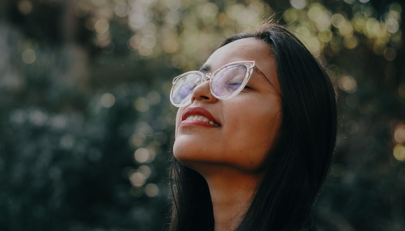 laughing health benefits — Woman Smiling Outside. Photo: Pexels