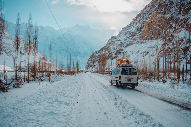 Van On Road In Snow In Mountains