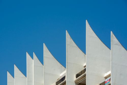 Free Contemporary architecture detail in La Baule-Escoublac with distinct facade design against blue sky. Stock Photo