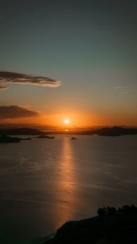 A breathtaking sunrise over the lake in Puno, Peru, with serene reflections creating a picturesque view.