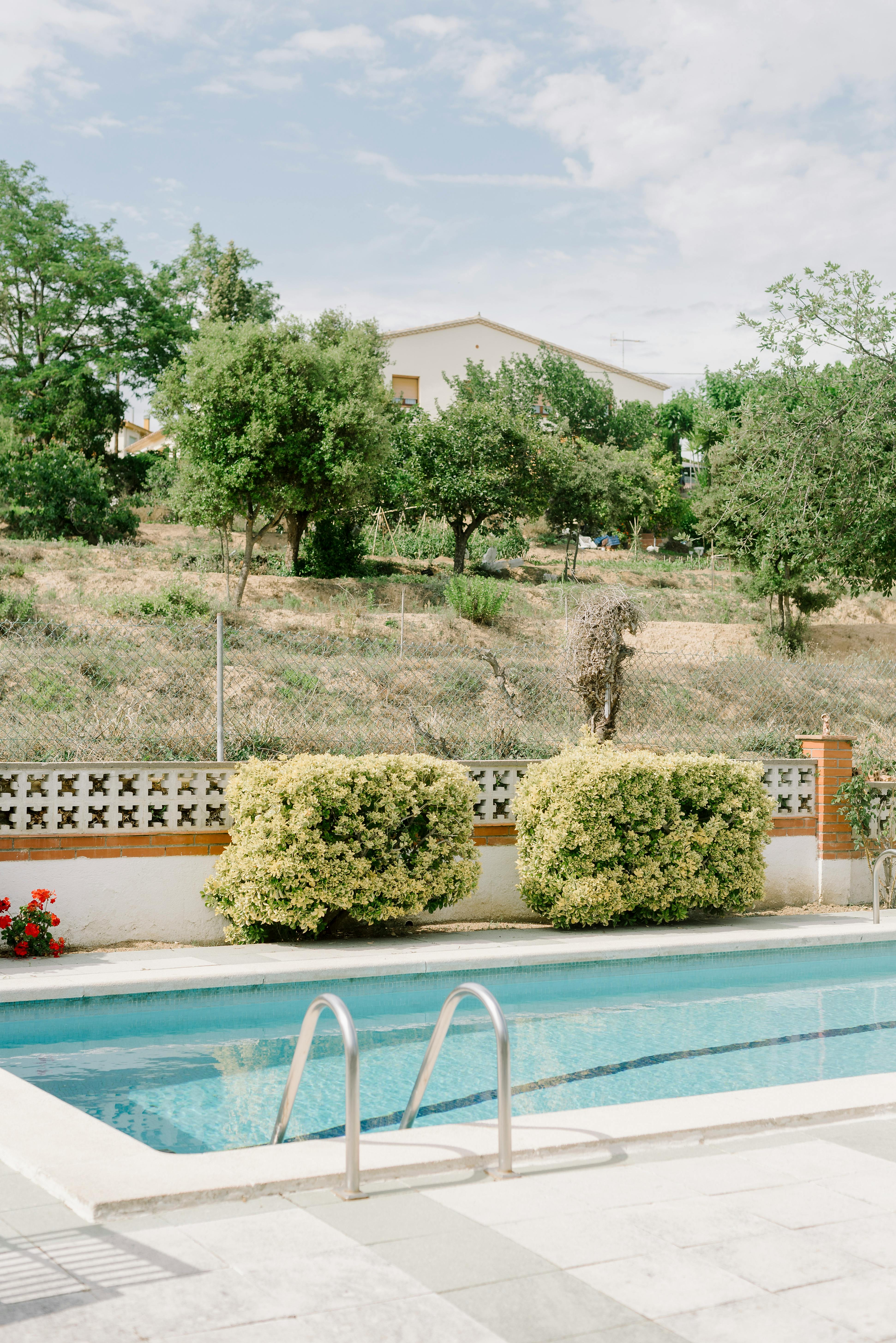 Professional pool technician servicing a crystal-clear swimming pool