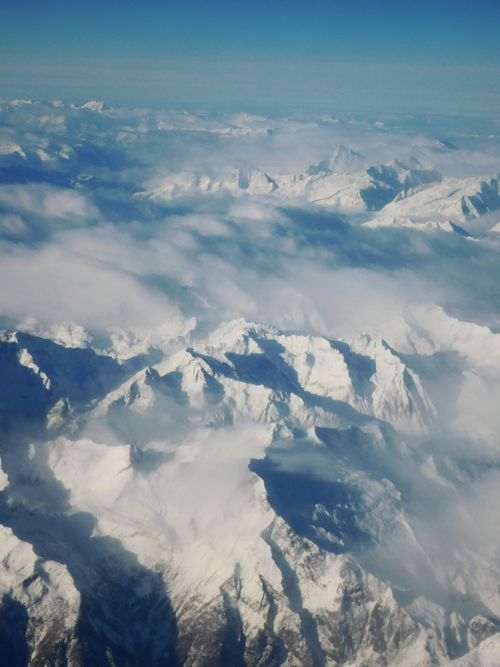 Free Breathtaking aerial view of snow-covered mountain peaks in the Italian Alps during winter. Stock Photo
