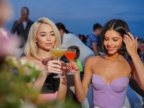 Brunette and Blonde Women with Cocktails
