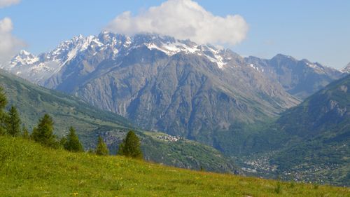 Free Stunning view of snow-capped mountains and lush valleys during summer in the Alps. Stock Photo