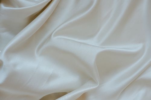 Free Elegant and soft white silk fabric texture, perfect for background and textile design. Stock Photo