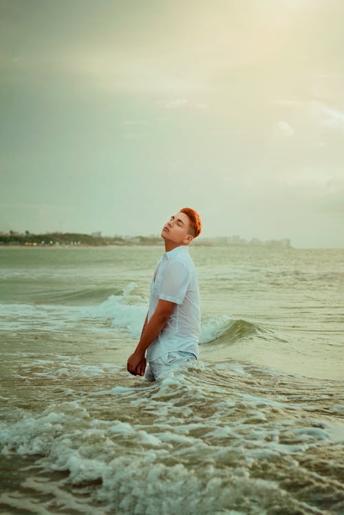 Person with Dyed Hair Posing in Shirt on Sea Shore